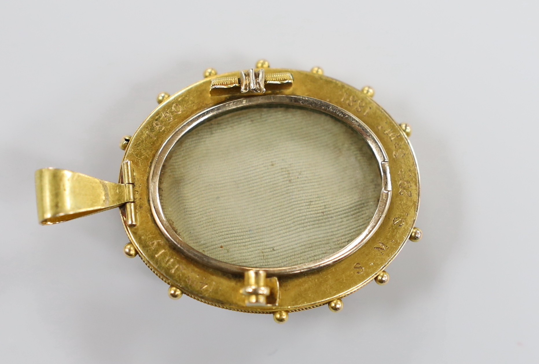 A Victorian yellow metal and hardstone cameo set oval pendant brooch (pin missing) with cannetile work decoration and engraved inscription verso, the stone carve with bust of a lady to dexter, overall 55mm, gross weight